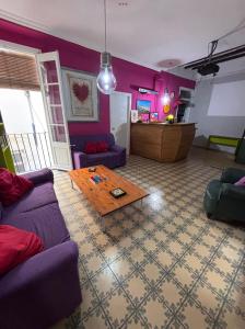 a living room with purple furniture and a table at Tarragona Rooms 4 in Tarragona