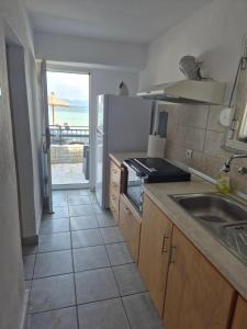 a kitchen with a sink and a view of the ocean at The Blue Pearl in Prinos