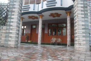 an entry to a house with columns and a patio at Ajwah Hotel Bahrain in Āīn +2 photos