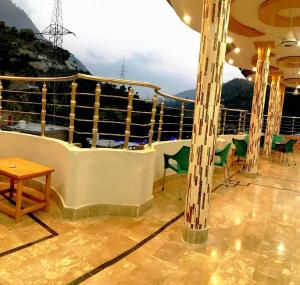 a balcony on a cruise ship with a table and chairs at Ajwah Hotel Bahrain in Āīn