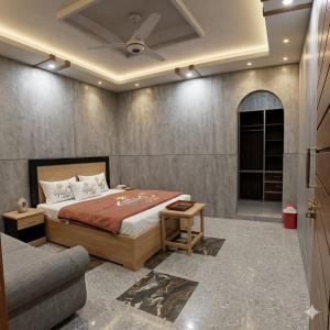 a bedroom with a bed and a couch at Ajwah Hotel Bahrain in Āīn