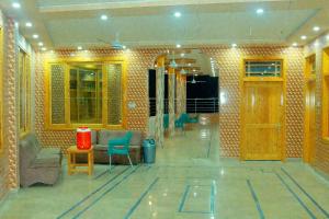 a living room with chairs and a table and a room at Ajwah Hotel Bahrain in Āīn