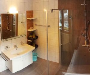 a bathroom with a sink and a shower at Haus Wachter in Pfunds +23 photos