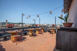 a group of tables and chairs on a roof at Bohemian Palace Florence in Florence