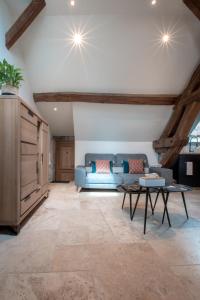 a living room with a blue couch and a table at Escale de Giulia in Beaune