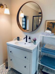 a bathroom with a white sink and a mirror at Atpūtas vieta Kannas in Tropmači