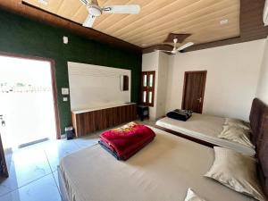 a bedroom with two beds and a green wall at The Empire Hotel in Sewāni +6 photos