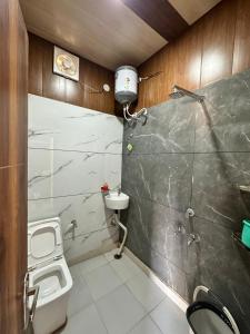 a bathroom with a toilet and a sink at The Empire Hotel in Sewāni