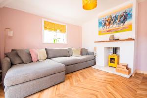 a living room with a couch and a fireplace at Beach Cottage Pets Welcome Sleeps 6 in Broadstairs