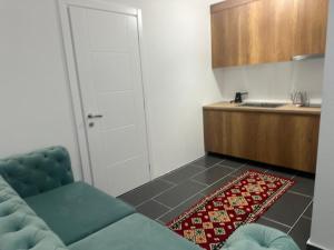 a living room with a couch and a kitchen at Enes apartament in Krujë