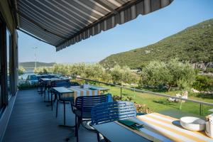 a row of tables and chairs on a deck at Boutique hotel MaViE - Adults Only in Neum