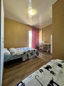 a bedroom with two beds and a table and a window at Hotel Yuzhanka in Sanzhiyka
