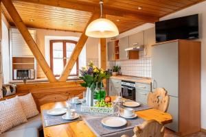 a kitchen with a table with a bowl of fruit on it at Alpaka Erlebnis-Ruhige Land-Auszeit in Dinkelsbühl +17 photos
