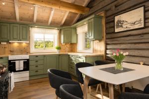 a kitchen with green cabinets and a table and chairs at Unique mountain retreat in Gol in Gol