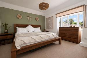 a bedroom with a large bed and a window at Beach Cottage Pets Welcome Sleeps 6 in Broadstairs