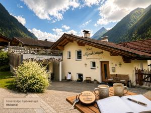 a building with a table in front of it at Ferienlodge Alpenkönigin Vacation in Stubai Valley in Neustift im Stubaital