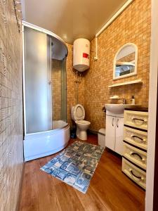 a bathroom with a tub and a toilet and a sink at Hotel Yuzhanka in Sanzhiyka +35 photos