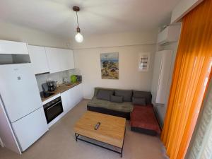 a small living room with a couch and a table at Affero Vita in Flogita +20 photos