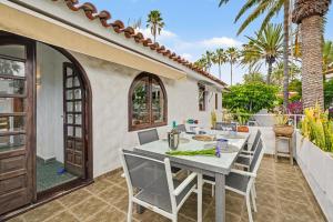 a white table and chairs on a patio at Private Pool And Ocean Views in Chayofa