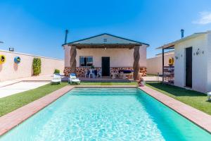 a swimming pool in the backyard of a house at Casa Rural Rafael in La Lantejuela