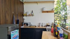 a kitchen with a counter top with a refrigerator at SugarHouse in Da Thanh +15 photos