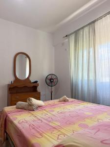 a bedroom with a large bed and a mirror at AS Orikum 1 in Orikum