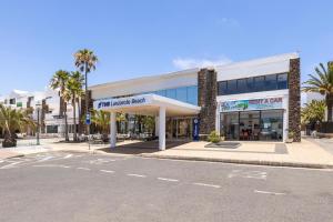 an empty street in front of a shopping center at THB Lanzarote Beach in Costa Teguise
