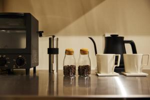 two bottles of granola sitting next to a microwave at 蔵宿あさぎやみたけ in Ome