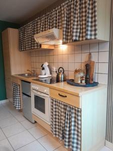 a small kitchen with a stove and a sink at Escapade en Alsace - gîte de charme pour deux à Bergheim in Bergheim +17 photos