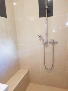 a bathroom with a shower with a tub and a sink at The Loka in Riga