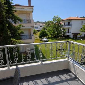 a balcony with a railing and a view of a yard at Meltemi Studios Polychrono in Polychrono