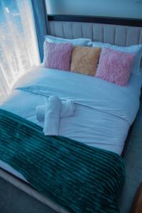 a large bed with many pillows on it at Kiesth Whiskaway in Kiambu