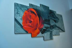 a painting of a red rose on a wall at Kiesth Whiskaway in Kiambu