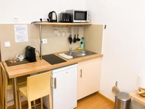 a small kitchen with a sink and a counter at Residence Akantha in Nice