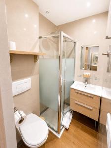 a bathroom with a shower and a toilet and a sink at Residence Akantha in Nice +14 photos