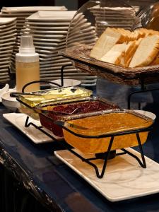 a table with two trays of food and bread at Avana Laem Chabang Boutique Hotel in Ban Laem Chabang