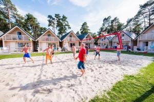 a group of people playing a game in the sand at Holiday Park & Resort Niechorze Rewal in Niechorze +52 photos
