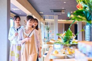 two women standing next to a table in a store at Onyado Satsuki in Tamana +43 photos