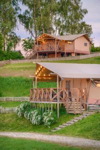 a house with a pavilion in front of it at "Wioska Wakacyjna Glamila" Mazury, nad jeziorem, podgrzewany basen, Glamping i domki rodzinne in Sterławki Wielkie