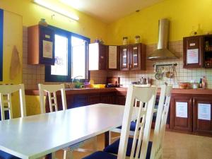 a kitchen with a white table and chairs in it at Guayaba Hostel in Las Lagunas