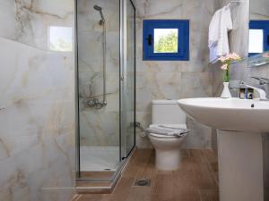 a bathroom with a shower and a toilet and a sink at Sifis in Loutro +24 photos