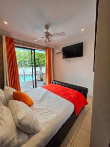 a bedroom with a bed with a red blanket on it at Sbukosezwe guest house in Johannesburg +67 photos
