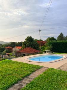 a swimming pool in the yard of a house at CASA DO CONDE MONTIER in Paredes de Coura