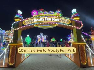 a entrance to a merry fun park at night at Swing & Pillows - Klebang, Melaka in Malacca +29 photos
