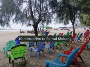 a bunch of colorful chairs on a beach at Swing & Pillows - Klebang, Melaka in Malacca