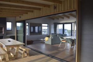 a living room with a couch and a table at Seals Tides - sleeps 12 in Cape St Francis