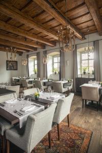 a dining room with tables and chairs and chandeliers at Zamek Topacz in Wrocław