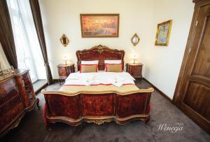 a bedroom with a large bed with a wooden frame at Sempre B&B in Płock