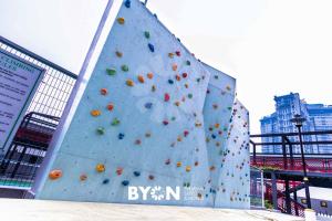a large rock climbing wall in a city at Geo38 Premium Suites Genting Highlands by BYON in Genting Highlands +63 photos