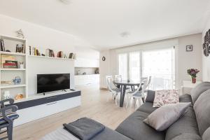 a living room with a couch and a tv and a table at Ardantza Bidea - baskeyrentals in Zumaia
